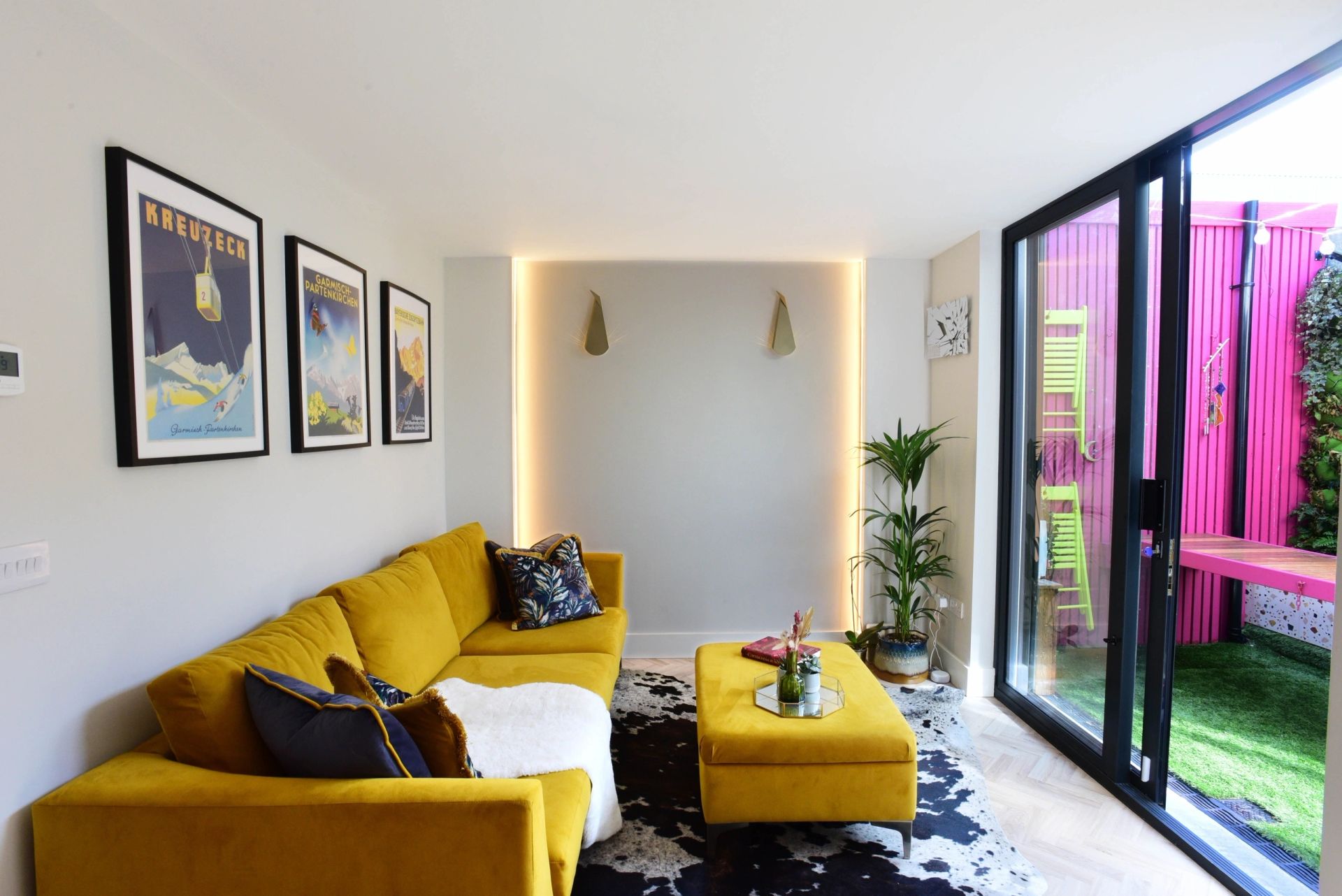Jenny's living room with yellow sofa and pink garden wall